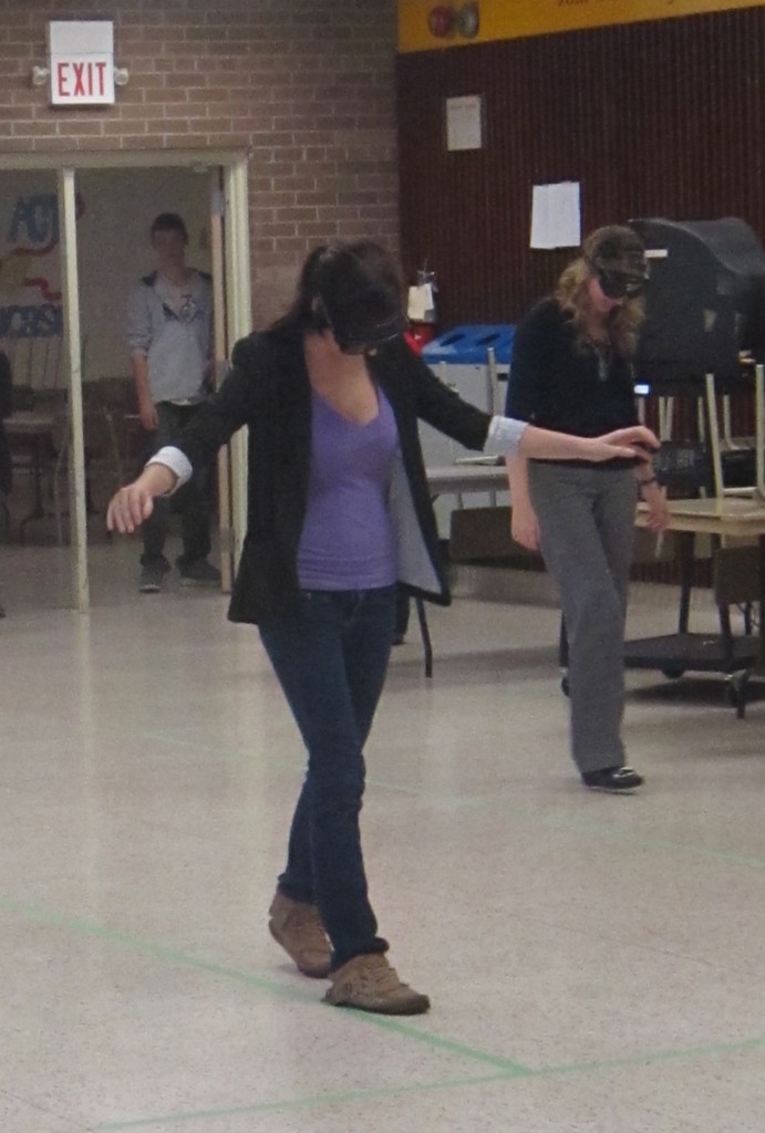 Two Nelson high school students do their best to stay on the green line wearing Fatal Vision goggles during a HAlton Regional Police RIDE program.