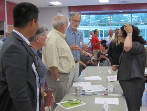 Members of the Community Engagement Team do a debrief after their Council Workshop session. Chris Walker is in the center.