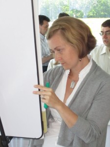 Donna Woods focuses on her flip chart as she uses colours to show different levels of comment.  Woods, along with three other woman, then take the 25 plus flip chart pages and make sense out of the notes for review the next day.