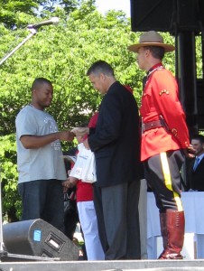 Citizen greeted by Mayor Mountie After being sworn in, the 31 New Canadians were given their Certificates of Citizenship and greeted warmly by Mike Wallace, MP, Joyce Savoline, MPP, Gary Carr, Chair of the Region of Halton and Rick Goldring, Mayor of Burlington – and then bid welcome to Canada by a member of the Royal Canadian Mounted Police.