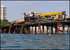 The crane accident was soon followed by a concrete pour that buckled some steel beams and revealed sub standard welding..  That’s when the arguments between the contractor, his sub contractors and the pier designers began – and then it all landed in the city’s lap when the contractor walked off the job.