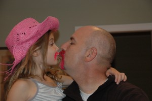 The boys won the bet - the daughter got a kiiss and a pink mustache of her own.