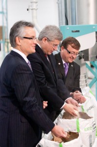 Prime Minister checks out the product at Ecysynthetix. Company CEO John van Leeuwen is on the left