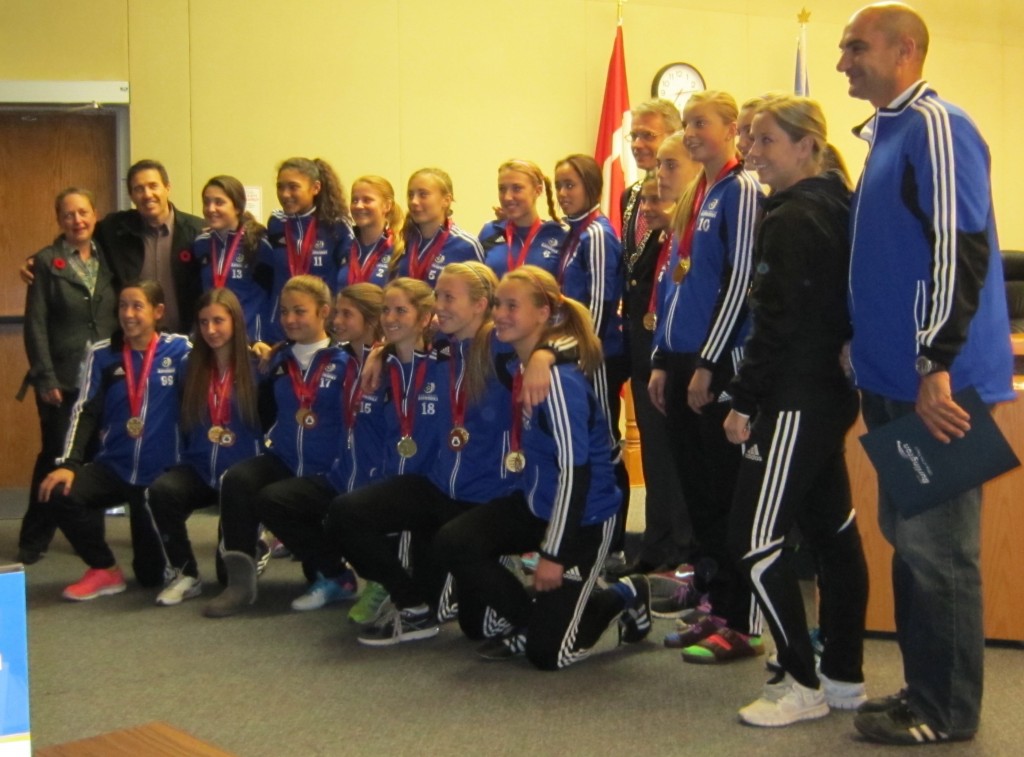 Burlington Bayhawks Under 14 girls soccer team, pose for the camera after being recognized by city council for an outstanding season