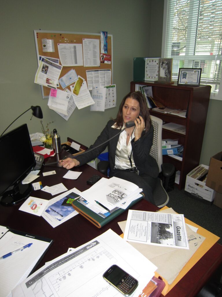 Meed Ward at her old city hall office - the desk is as cluttered in her new space where she tends to fill up her voice mail box and overspend her postage allowance. She promises to get back to people within 24 hours - and delivers on that promise. Now she wants to deliver onher promise to keep spening in line with what is in the bank.