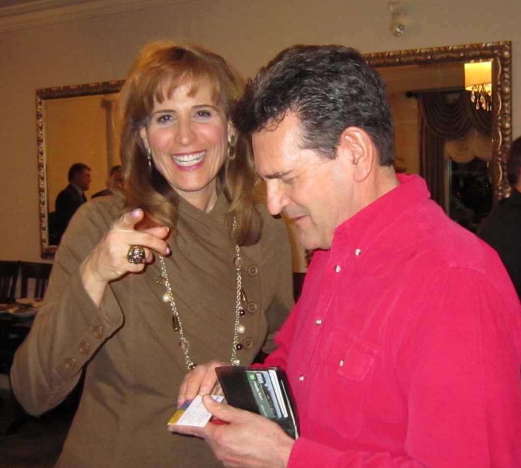 Ward 1 Councillor Rick Craven digging out a business card for provincial Liberal leadership hopeful Sandra Pupatello. 