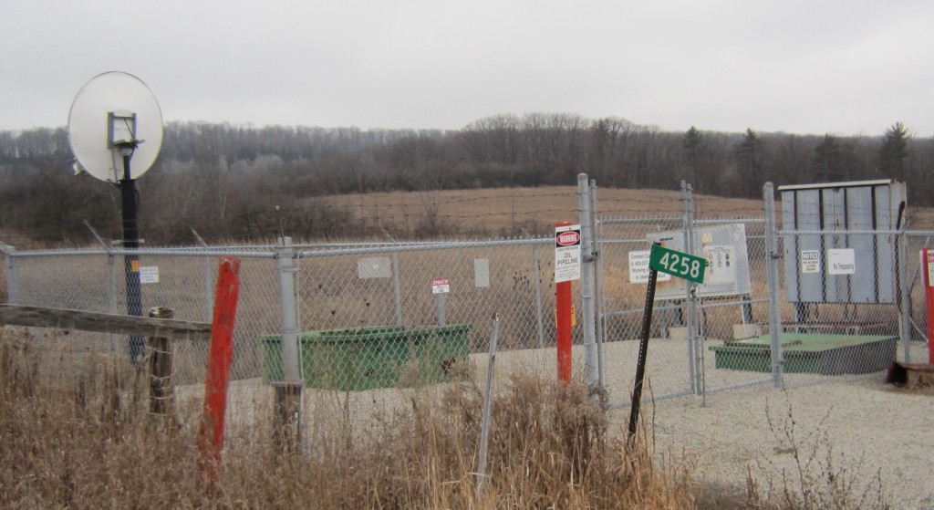 The Enbridge pipeline monitoring site on Walkers Line – looking west. Enbridge can control the flow of oil through this location from their control rooms in Edmonton. Does that make the line safer?  The satellite dish in the upper left handles the signals