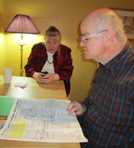 Doug Brown and Susan Lewis look over a 1982 copy of the city's bus schedule. 