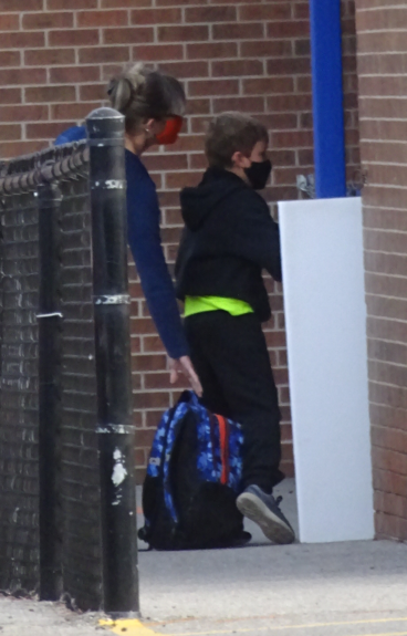 Student with parent - getting saniitized and checked iin Sept 14