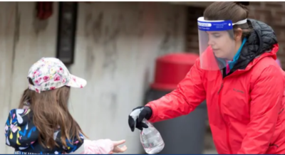 student being hand sanitized