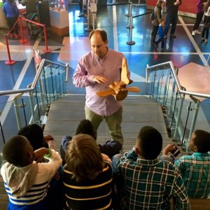 Ken Hall explaing a piece of his work to students