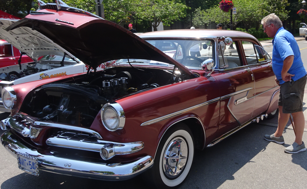 Man with a cane - maroon car