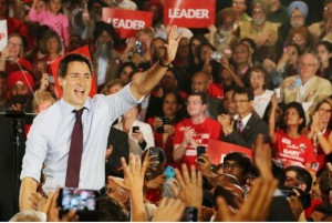 Trudeau Justin with signs behind
