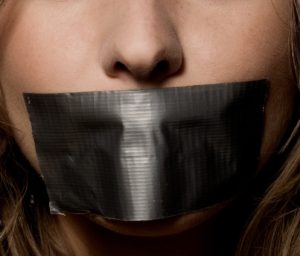 a woman's mouth sealed with a scotch tape